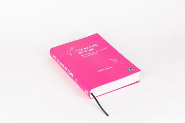 The finished Nature of Code book with its bright pink cover