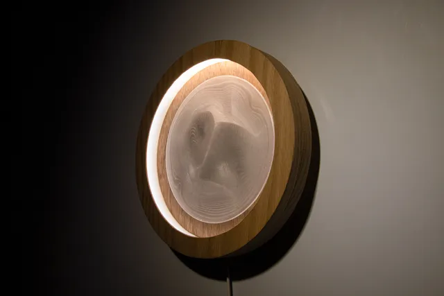 Angled view of the Dune lamp showing shadows across its translucent center