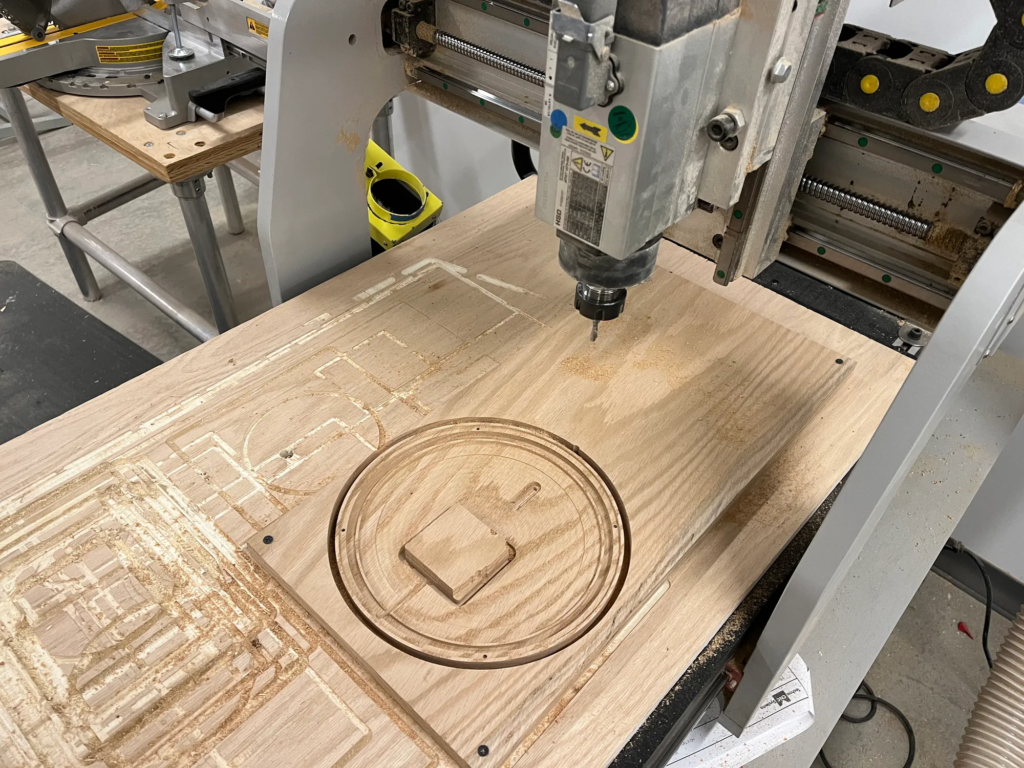 wood stock on a cnc machine, milled to the base of the fixture