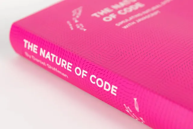 Close-up of the bright pink cover of The Nature of Code