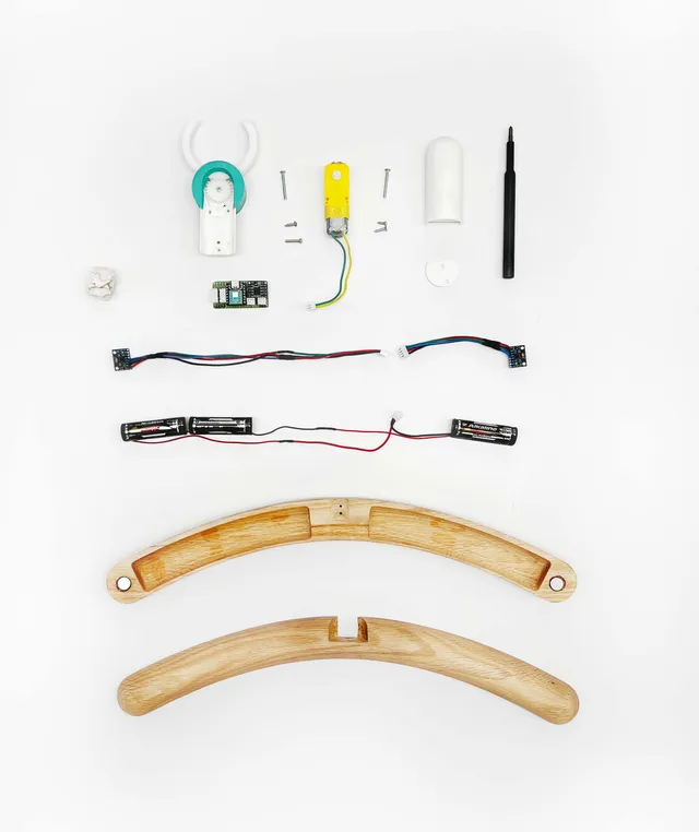 Exploded view of the hanger's wooden arms, motor, electronics, fasteners, and hook components