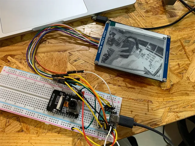 Solaroid prototype with a camera module on a breadboard connected to an e-paper display